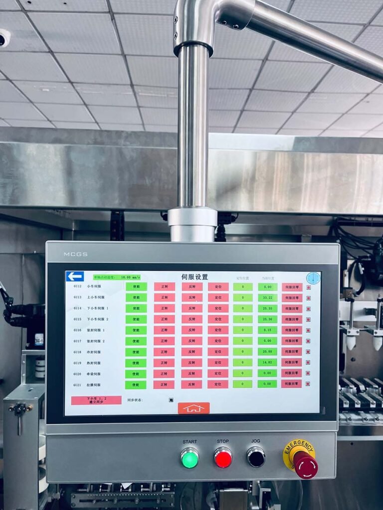 MCGS touchscreen HMI servo parameters control panel on a CE-marked HMK series packaging machine.