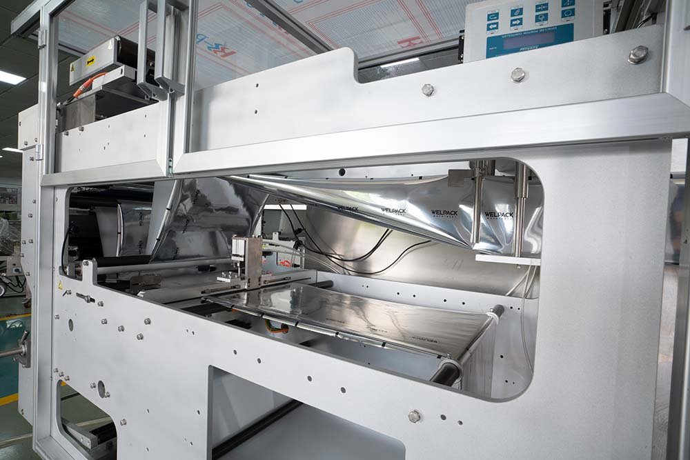 Spout pouch filling machine film-unwind and forming assembly