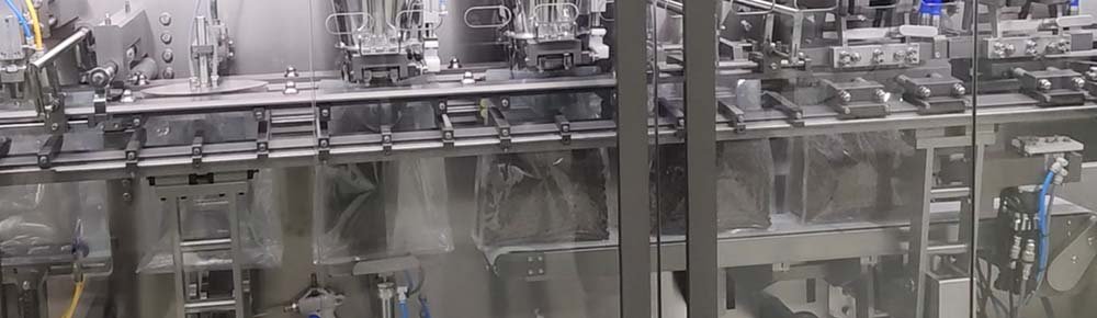 Rotary premade pouch filling and sealing line with dosing equipment